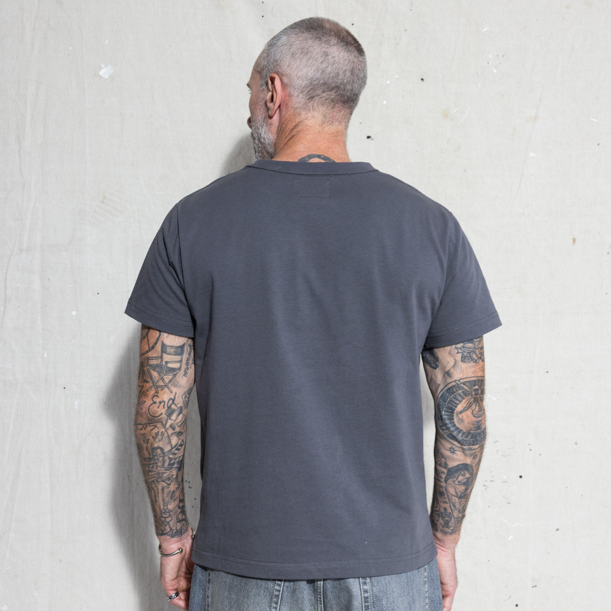 Premium Fitted Heritage Tee in Washed Black, back view on model